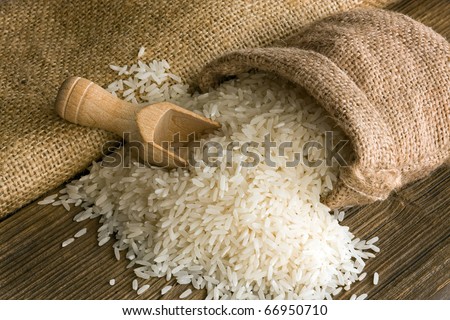 White uncooked rice in small burlap sack