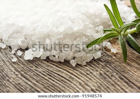 Crystals of sea salt on wooden background