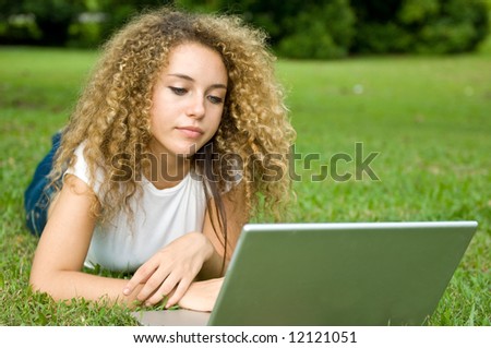 A beautiful young woman using a portable computer outside