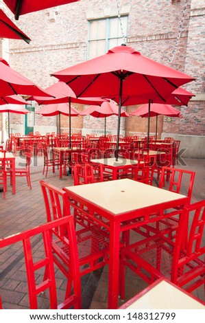Red table and chairs in empty cafe. Japan.