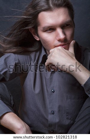 Portrait of an elegant young long haired male model
