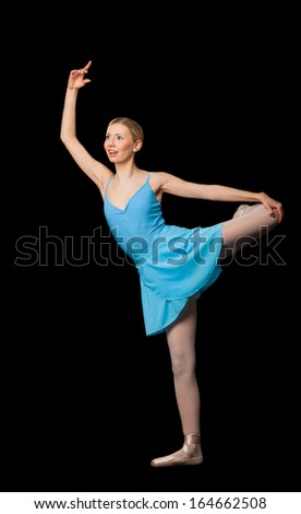 Beautifull young blond ballerina dance. Isolated on the black background