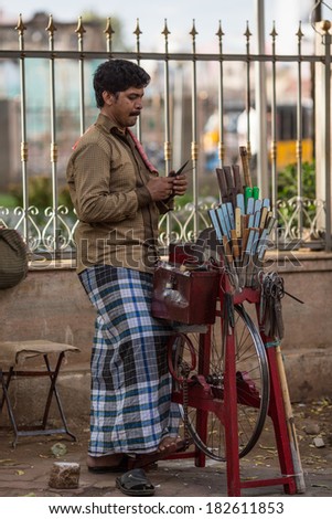 MADURAI, INDIA-FEBRUARY 16: Trader on the street of Indian town on February 16, 2013 in Madurai, India. Trader on a city street province Tamil Nadu