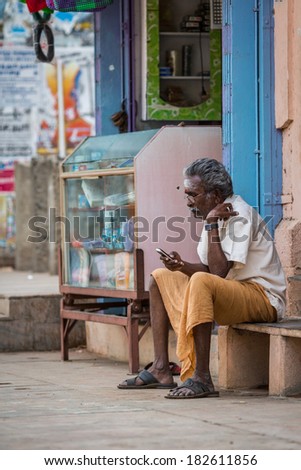 MADURAI, INDIA-FEBRUARY 16: Trader on the street of Indian town on February 16, 2013 in Madurai, India. Trader on a city street province Tamil Nadu