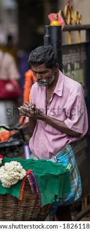 TRICHY, INDIA-FEBRUARY 14: Trader on the street of Indian town on February 14, 2013 in Trichy, India. Trader on a city street province Tamil Nadu