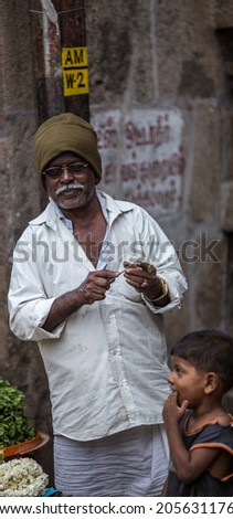 TRICHY, INDIA-FEBRUARY 14: Street of Indian city 14, 2013 in Trichy, India. Man on the street of indian town