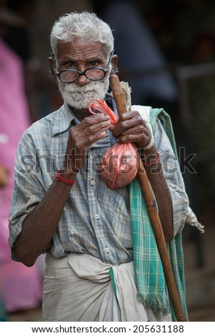 TRICHY, INDIA-FEBRUARY 14: Street of Indian city 14, 2013 in Trichy, India. Old man on the street of indian town.