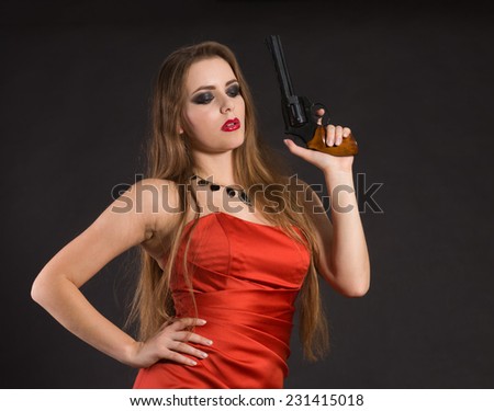 Green-eyed lady in a red dress with a gun