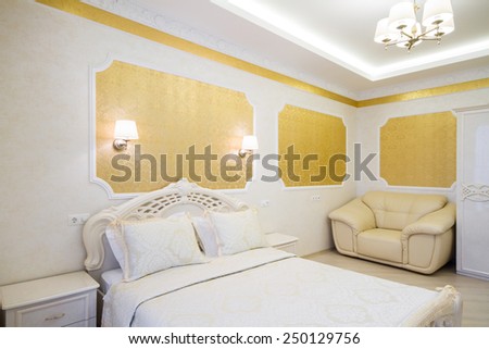 Luxurious bed with cushion in royal bedroom interior. Hotel room