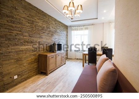 Modern interior of a living room studio. Kitchen with dinner table
