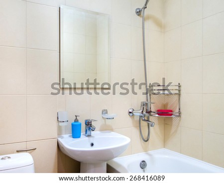 Bathroom interior with a large mirror and washbasin