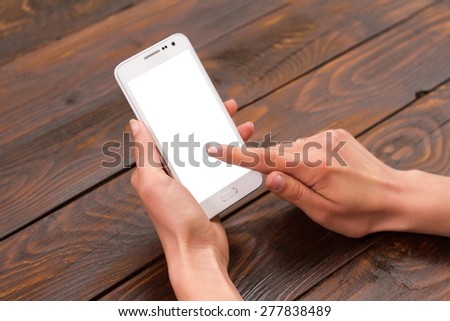 Mobile phone in the hands of a girl with a blank screen
