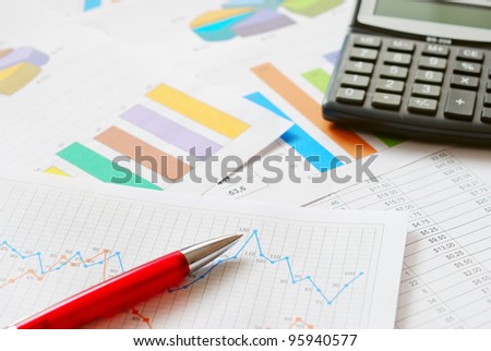Financial documents with red pen and calculator