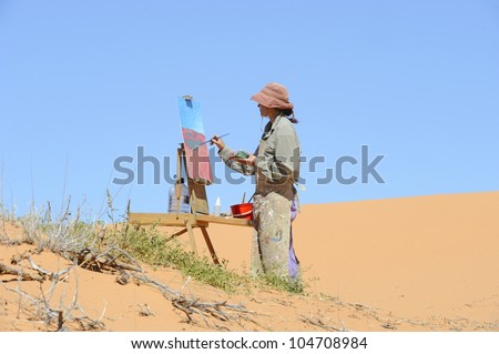 Debra Hilditch, landscape painter at work on location in the Kalahari desert,South Africa