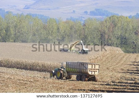 UNDERBERG, SOUTH AFRICA -MAY 1; Industrial scale Agriculture. Contractors reap maize on May 1, 2013, Underberg, Kwazulu Natal, South Africa. The crop is made into silage for winter feed for dairy cows
