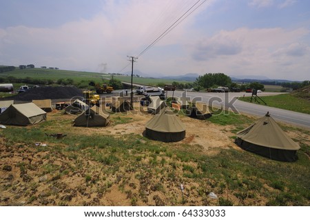 UNDERBERG, SOUTH AFRICA-NOV 1: sewerage and refuse from a roadworks camp on the banks of the  river upstream from  the town pumping weir, pollute the water supply Nov 1,  2010 in Underberg, S Africa.