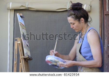 TWEE RIVIEREN - MAY 22: Debra Hilditch, a south african landscape artist works on a canvas of a  kalahari landscape on May 22, 2011 for an upcoming exhibition of south african landscapes