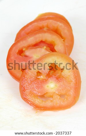 pieces of a sliced tomato and a knife