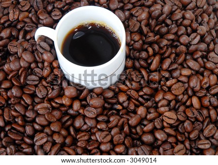 White Cup of Coffee and Toasted coffee beans