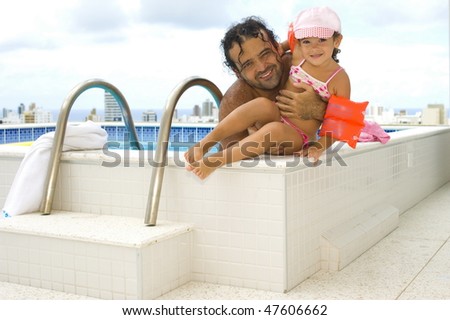 Happy Adult and Child in the swimming pool of cover flat .