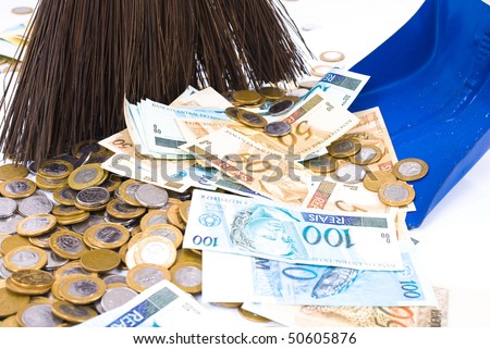 Paper money and Coins on the floor being swept with a broom .