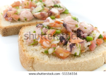 Fresh bread, cut into slice with octopus salad .