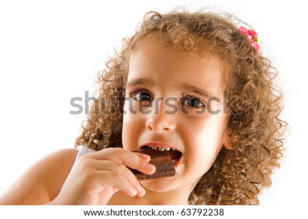 Child eating chocolate with a dirty mouth .