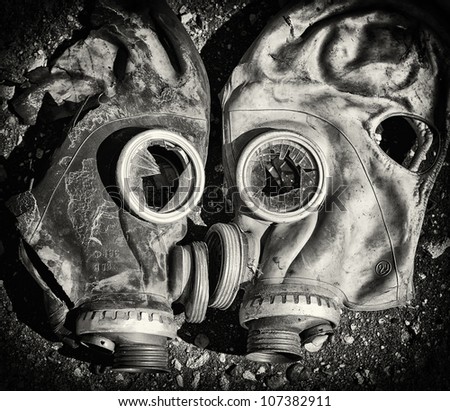 Death kiss. Black and white gas masks with broken glass. Black and white photo.