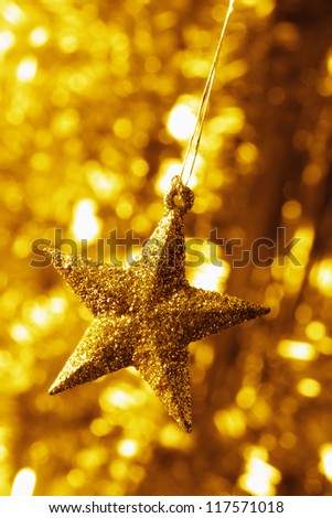 Christmas decoration. Star with light background. Toned to gold.