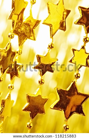 Christmas decoration. Star with light background. Toned to gold.
