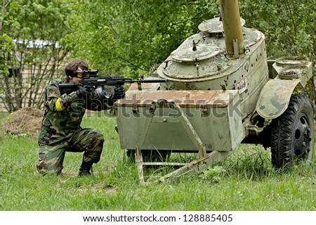 NIZHNY NOVGOROD, RUSSIA - MAY 13: Airsoft player fighting on may 13, 2012 in shooting ground near Nizhny Novrogorod, Russia. Airsoft is a recreational activity with replica firearms.