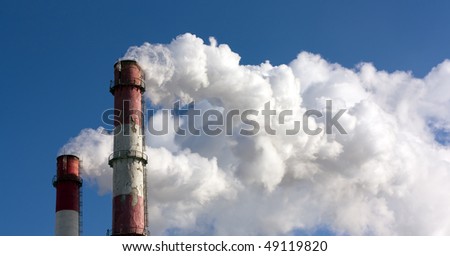 Two smoking towers against the pure blue sky.