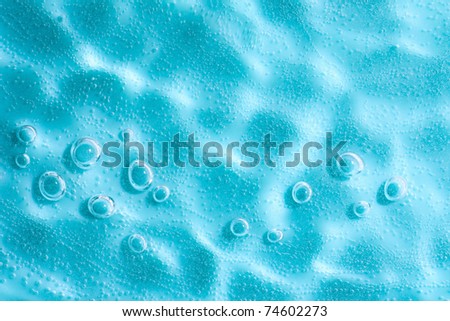Water ripple with sun spot in Blue abstract water with bubbles. Macro. Closeup. Copy-space.