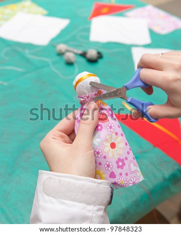 Parents help children to make traditional toys from rags