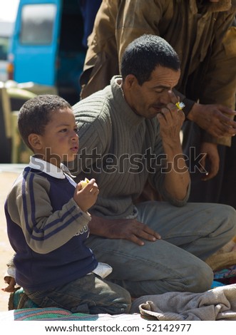 FES - APRIL 16: Father and son sell products at a market (souk) in a village near Fes in Morocco April 16, 2010 Fes, Morocco.