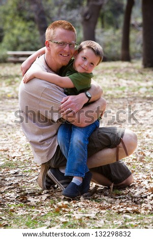 Happy little boy hugging his father