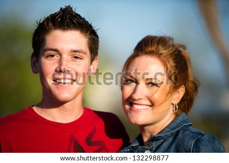 Happy mother and teen son smiling