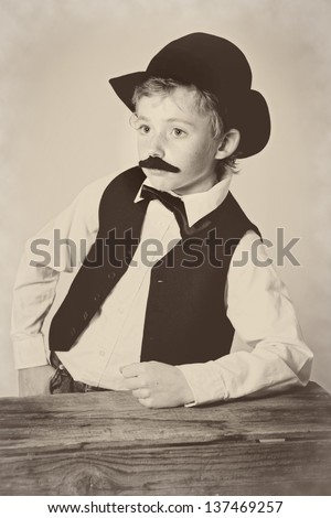Young boy dressed as a western bartender; vintage