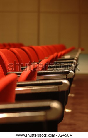 A line of red theatre chairs - short depth of field.