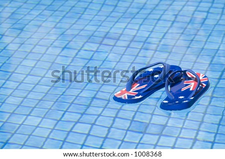 Pair of sandals printed with the Australian flag floating on a pool.