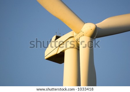 Closeup wind generator on a wind farm. Generators are held 100metres (300feet) above the ground and each blade is 30metres (100feet) long