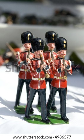 Collection of small toy figurines of typical English soldier marching band