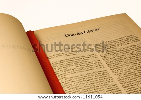 A large open Bible in Spanish language, open to Book of Genesis. Isolated