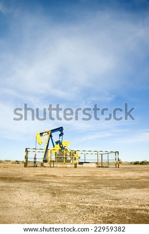 Portrait long shot of an oil pump jack located in the Argentina desert