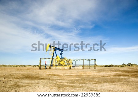 Wide shot of an oil pump jack located in the Argentina desert