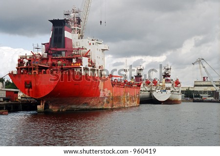 Red ship under repair at dockyard