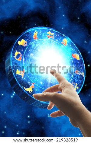 hand touching the zodiac wheel