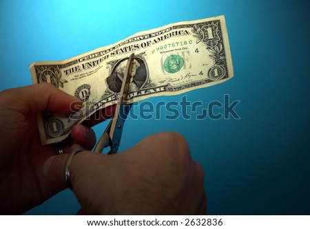 scissors cutting a dollar banknote as concept for depreciation of money value