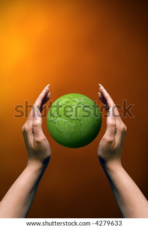 female hands holding a green earth globe