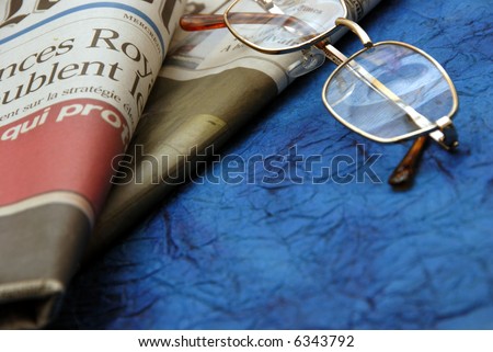 reading glasses and international newspapers
